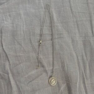 Mejuri winged necklace with adjustable lengths.